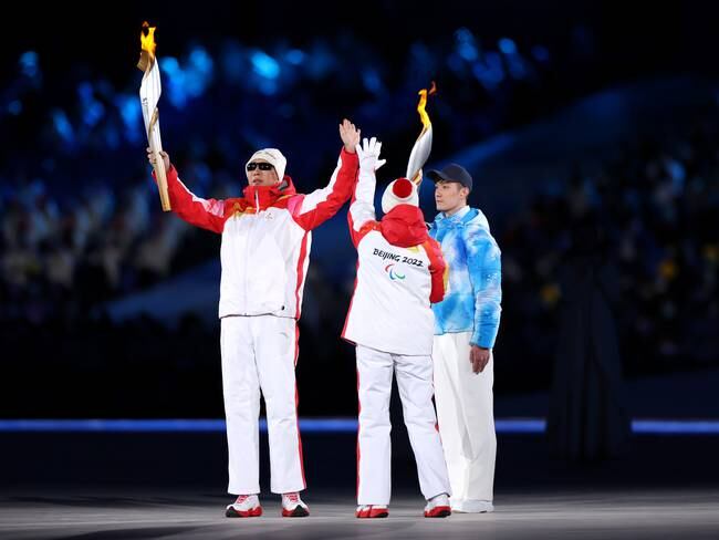 BEIJING, CHINA - MARCH 04: Torchbearers carry the Olympic flame during the Opening Ceremony of the Beijing 2022 Winter Paralympics at the Beijing National Stadium on March 04, 2022 in Beijing, China. (Photo by Lintao Zhang/Getty Images)