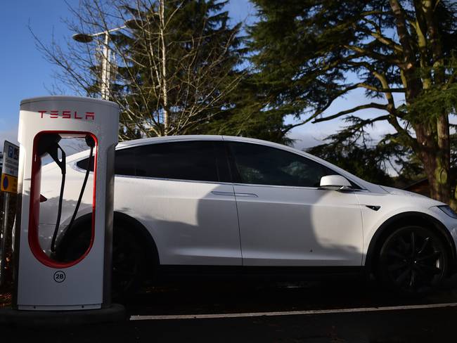 STOKE ON TRENT, ENGLAND - DECEMBER 10:  A Tesla car is charged at electric vehicle charging pod point at Trentham Estate on December 10, 2021 in Stoke on Trent, England. (Photo by Nathan Stirk/Getty Images)