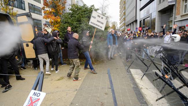 BRUSSELS, BELGIUM - NOVEMBER 21: Police spray protesters with gas as they gather in front of the Gare du Nord for the demonstration entitled &quot;Together for freedom&quot; on November 21, 2021 in Brussels, Belgium. Police estimate 35,000 people gathered at 1 pm in front of the Gare du to protest against the Covid pass, which they consider to be a factor of division in the society. (Photo by Thierry Monasse/Getty Images)