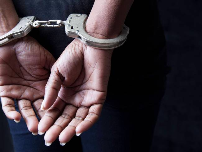Black woman in handcuffs / Bill Oxford