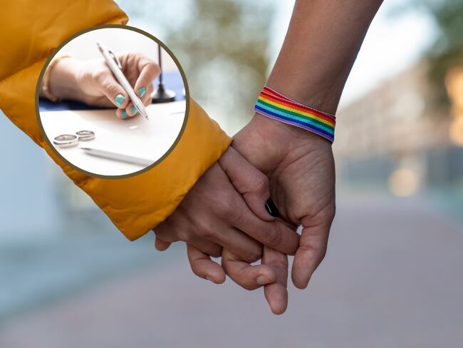 Dos personas de la comunidad LGTBIQ+ cogidas de la mano y de fondo firmando papeles de compromiso civil. (Fotos vía Getty Images)