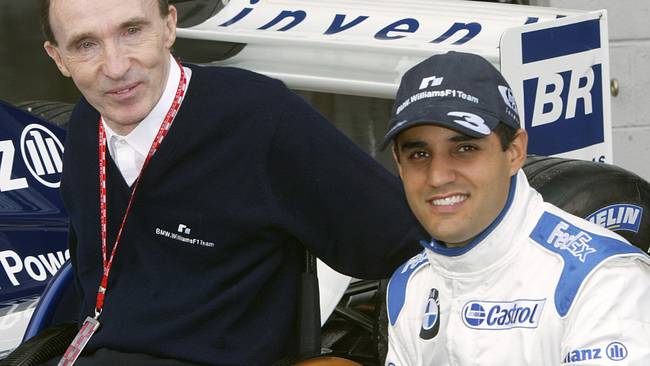 Columbian BMW-Williams driver Juan Pablo Montoya (R) pose with English BMW-Williams team Director Frank Williams in the pits of the Silverstone racetrack, 18 July 2003, before the first free practice session two days before the British Formula One Grand Prix.   AFP PHOTO PIERRE ANDRIEU  (Photo credit should read PIERRE ANDRIEU/AFP via Getty Images)