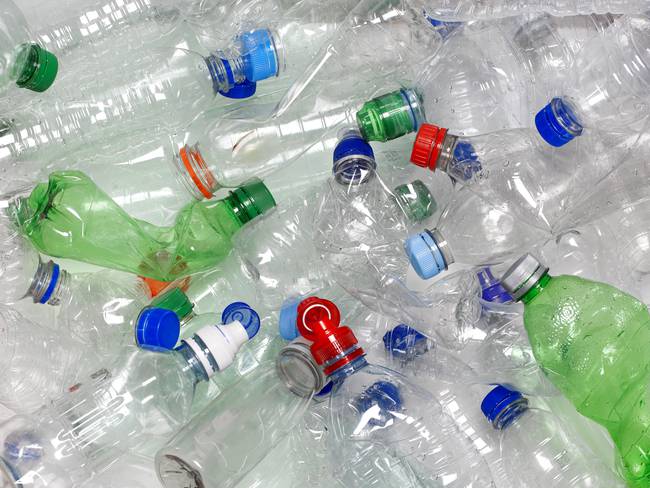 Discarded used water bottles in recycling bin.  The lids can be recycled as well if reattached to the water bottle. Photo: Getty Images.