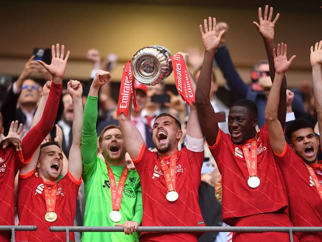 LONDON, ENGLAND - MAY 14: Jordan Henderson of Liverpool lifts The Emirates FA Cup trophy after their sides victory during The FA Cup Final match between Chelsea and Liverpool at Wembley Stadium on May 14, 2022 in London, England. (Photo by Michael Regan - The FA/The FA via Getty Images)