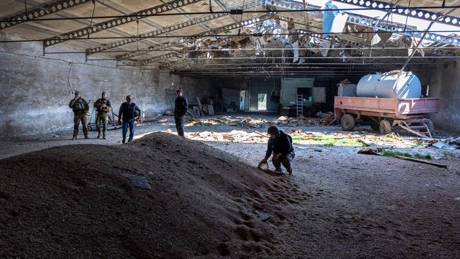 NOVOVORONTSOVKA, UKRAINE - MAY 06: Local government officials and  Ukrainian soldiers inspect a wheat grain warehouse earlier shelled by Russian forces on May 06, 2022 near the frontlines of Kherson Oblast in Novovorontsovka, Ukraine. (Photo by John Moore/Getty Images)