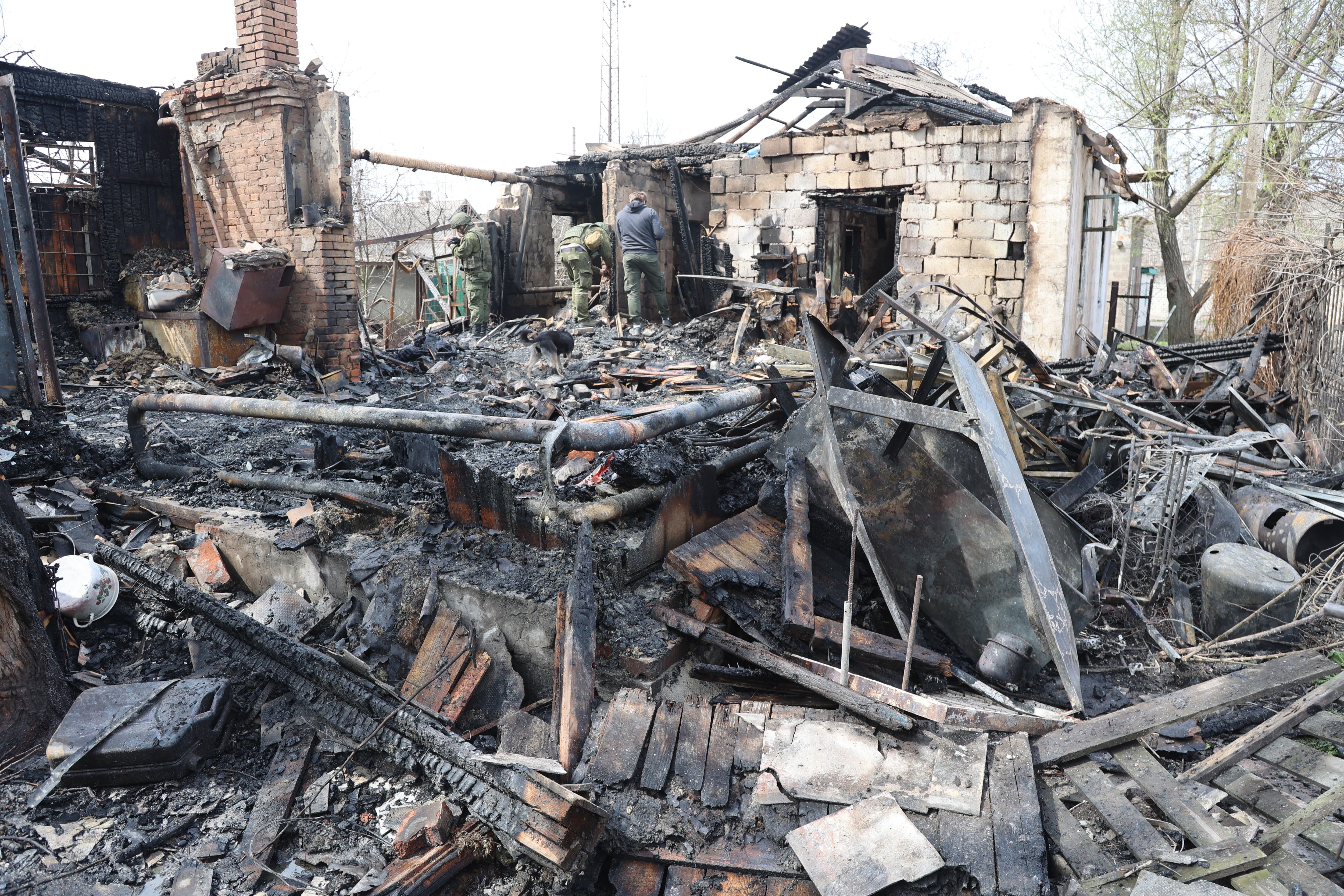 DONETSK, UKRAINE - APRIL 10: Firefighters conduct work on debris after shelling hit residential areas at the Leninsky district's Yelenovka village of the pro-Russian separatists-controlled Donetsk, Ukraine on April 10, 2022. As a result of the shelling of the village, a private house in the residential sector was completely destroyed by fire (Photo by Leon Klein/Anadolu Agency via Getty Images)