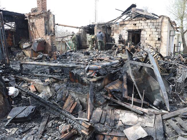 DONETSK, UKRAINE - APRIL 10: Firefighters conduct work on debris after shelling hit residential areas at the Leninsky district's Yelenovka village of the pro-Russian separatists-controlled Donetsk, Ukraine on April 10, 2022. As a result of the shelling of the village, a private house in the residential sector was completely destroyed by fire (Photo by Leon Klein/Anadolu Agency via Getty Images)