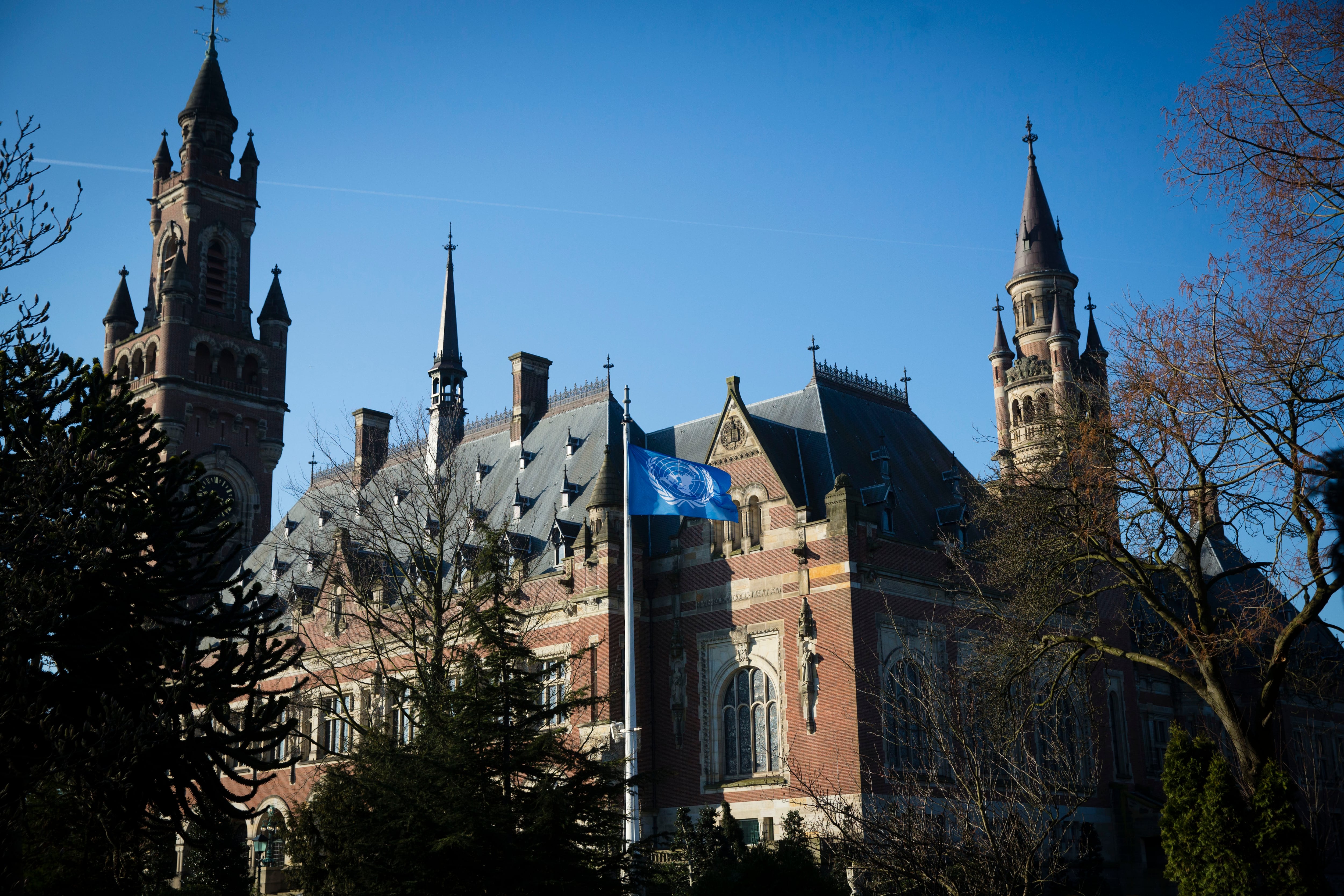 THE HAGUE NETHERLANDS - MARCH 7:  The United Nations flag waves ouside the International Criminal Court of Justice or Peace Palace on the first day of hearings between Ukrain and Russia on March 7, 2022 in The Hague The Netherlands. Ukraine is petitioning the ICJ to classify Russia's invasion as a genocide and issue an injunction under the UN Convention against Genocide. (Photo by Michel Porro/Getty Images)