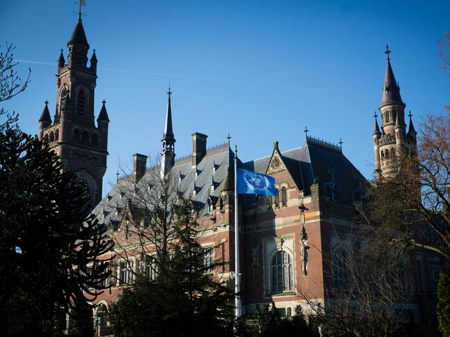 THE HAGUE NETHERLANDS - MARCH 7: The United Nations flag waves ouside the International Criminal Court of Justice or Peace Palace on the first day of hearings between Ukrain and Russia on March 7, 2022 in The Hague The Netherlands. Ukraine is petitioning the ICJ to classify Russia's invasion as a genocide and issue an injunction under the UN Convention against Genocide. (Photo by Michel Porro/Getty Images)