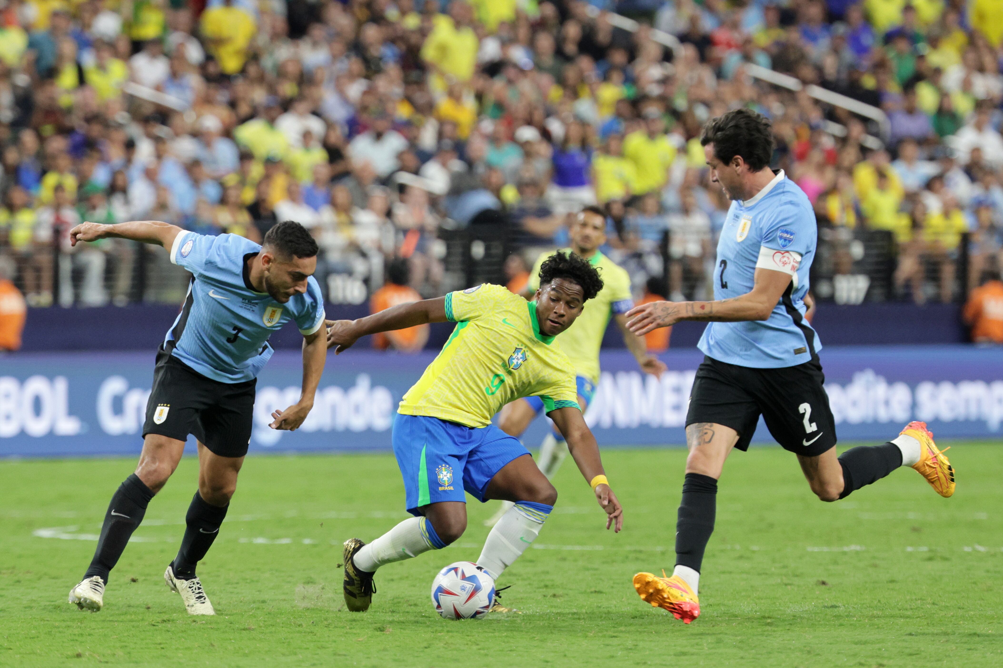 Las Vegas (United States), 07/07/2024.- Endrick Moreira of Brazil (C) in action against Sebastian Caceres of Uruguay and Jose Gimenez of Uruguay (R) during the CONMEBOL Copa America 2024 Quarter-finals match between Uruguay and Brazil, in Las Vegas, Nevada, USA, 06 July 2024. (Brasil) EFE/EPA/ALLISON DINNER