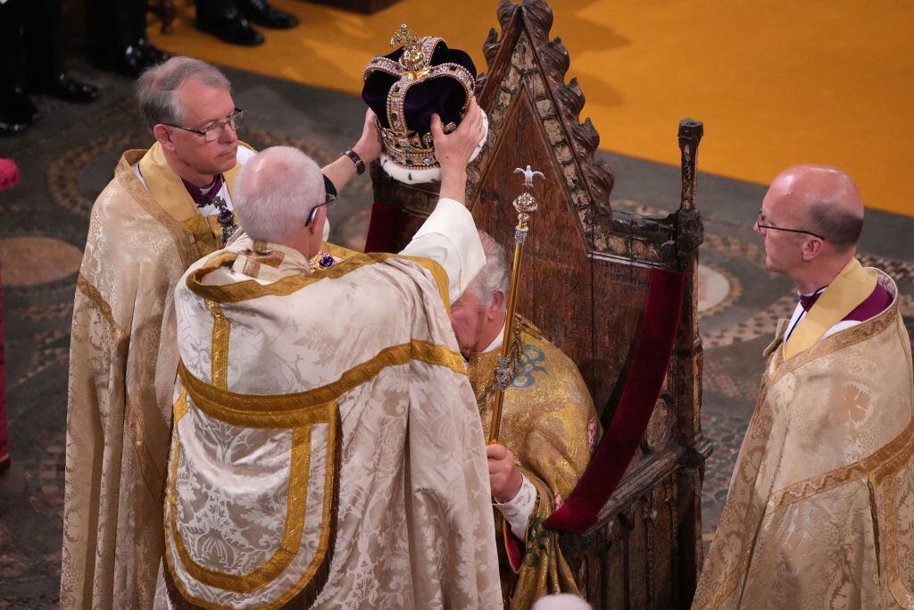 LONDON, ENGLAND - MAY 06: King Charles III is crowned with St Edward's Crown by The Archbishop of Canterbury the Most Reverend Justin Welby during his coronation ceremony in Westminster Abbey on May 6, 2023 in London, England. The Coronation of Charles III and his wife, Camilla, as King and Queen of the United Kingdom of Great Britain and Northern Ireland, and the other Commonwealth realms takes place at Westminster Abbey today. Charles acceded to the throne on 8 September 2022, upon the death of his mother, Elizabeth II. (Photo by Aaron Chown - WPA Pool/Getty Images)