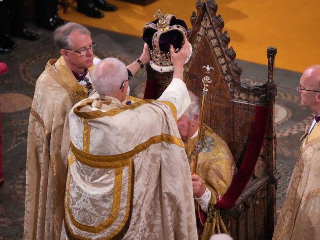 LONDON, ENGLAND - MAY 06: King Charles III is crowned with St Edward's Crown by The Archbishop of Canterbury the Most Reverend Justin Welby during his coronation ceremony in Westminster Abbey on May 6, 2023 in London, England. The Coronation of Charles III and his wife, Camilla, as King and Queen of the United Kingdom of Great Britain and Northern Ireland, and the other Commonwealth realms takes place at Westminster Abbey today. Charles acceded to the throne on 8 September 2022, upon the death of his mother, Elizabeth II. (Photo by Aaron Chown - WPA Pool/Getty Images)
