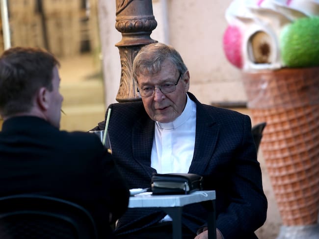 El ex arzobispo de Sidney, el cardenal australiano George Pell, se sienta con un joven sacerdote en un bar cerca de la Plaza de San Pedro el 4 de octubre de 2020 en la Ciudad del Vaticano, Vaticano. El cardenal Pell llegó de Sídney a Roma el 30 de septiembre de 2020. Foto de Franco Origlia/Getty Images.
