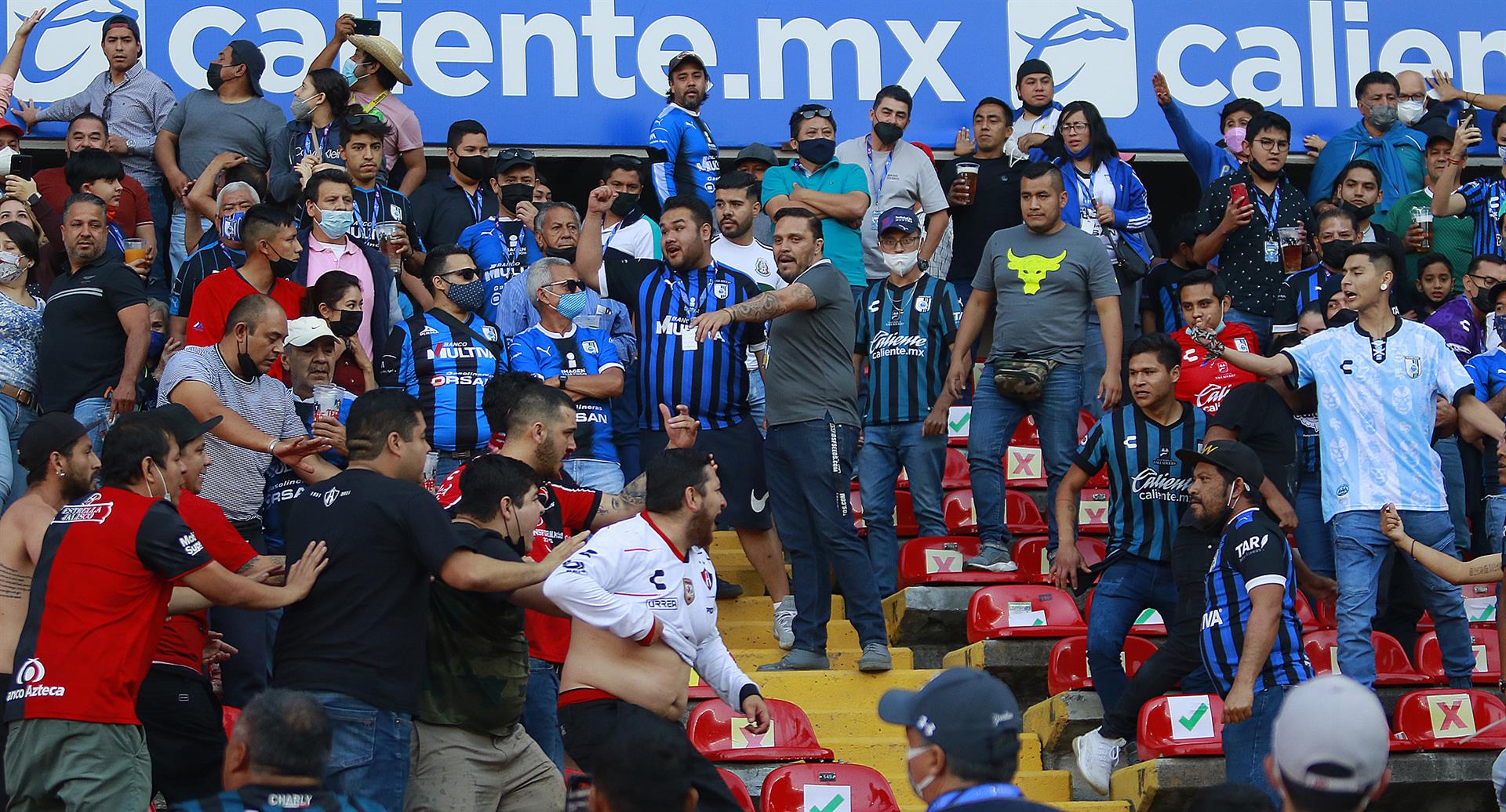 Algunos asistentes comenzaron a invadir la cancha huyendo de la violencia que había en las tribunas, donde aficionados del Querétaro y el Atlas se peleaban con cinturones, palos, sillas y otros artefactos
