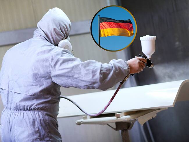 Pintor industrial mientras pinta una pieza de color blando y de fondo la bandera de Alemania (Fotos vía Getty Images)