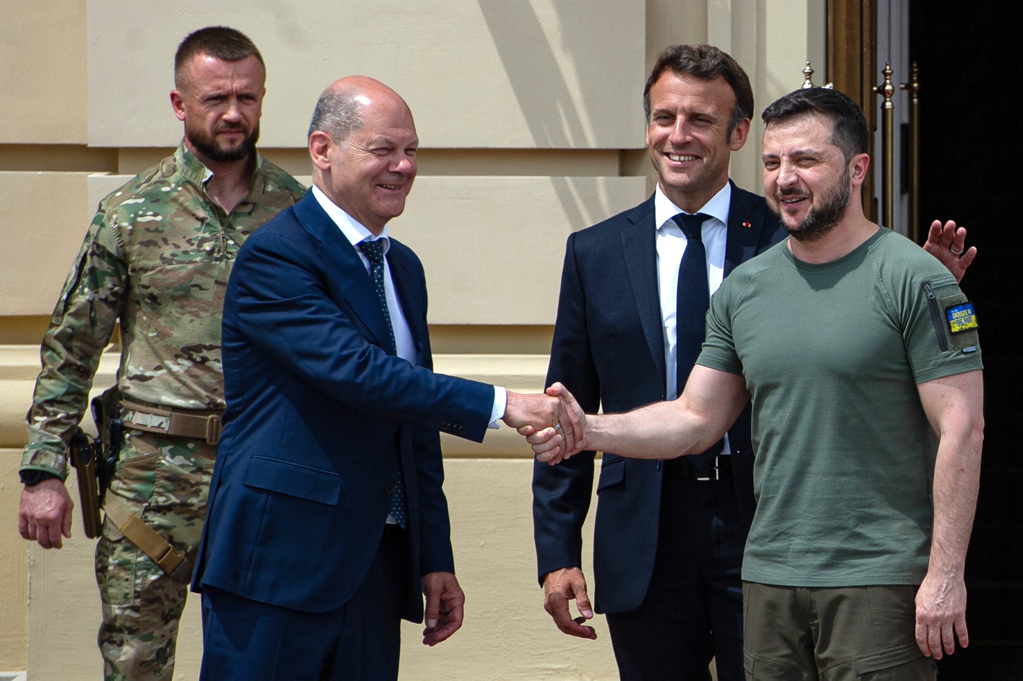 KYIV, UKRAINE - JUNE 16: Ukrainian President Volodymyr Zelensky shakes hands with German Chancellor Olaf Scholz as France's President Emmanuel Macron taps him on the back on June 16, 2022 in Kyiv, Ukraine. The leaders made their first visits to Ukraine since the country was invaded by Russia on February 24th. (Photo by Alexey Furman/Getty Images)