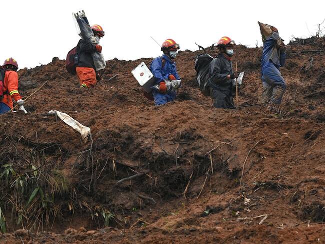 Rescue workers comb through the site of where China Eastern flight MU5375 crashed on March 21, near Wuzhou in southwestern Chinas Guangxi province on March 24, 2022. - The cause of the disaster which killed 132 people has mystified aviation authorities who have scoured rugged terrain for clues, finding no survivors from what is almost certain to be China's deadliest plane crash in nearly 30 years. (Photo by Noel Celis / AFP) (Photo by NOEL CELIS/AFP via Getty Images)