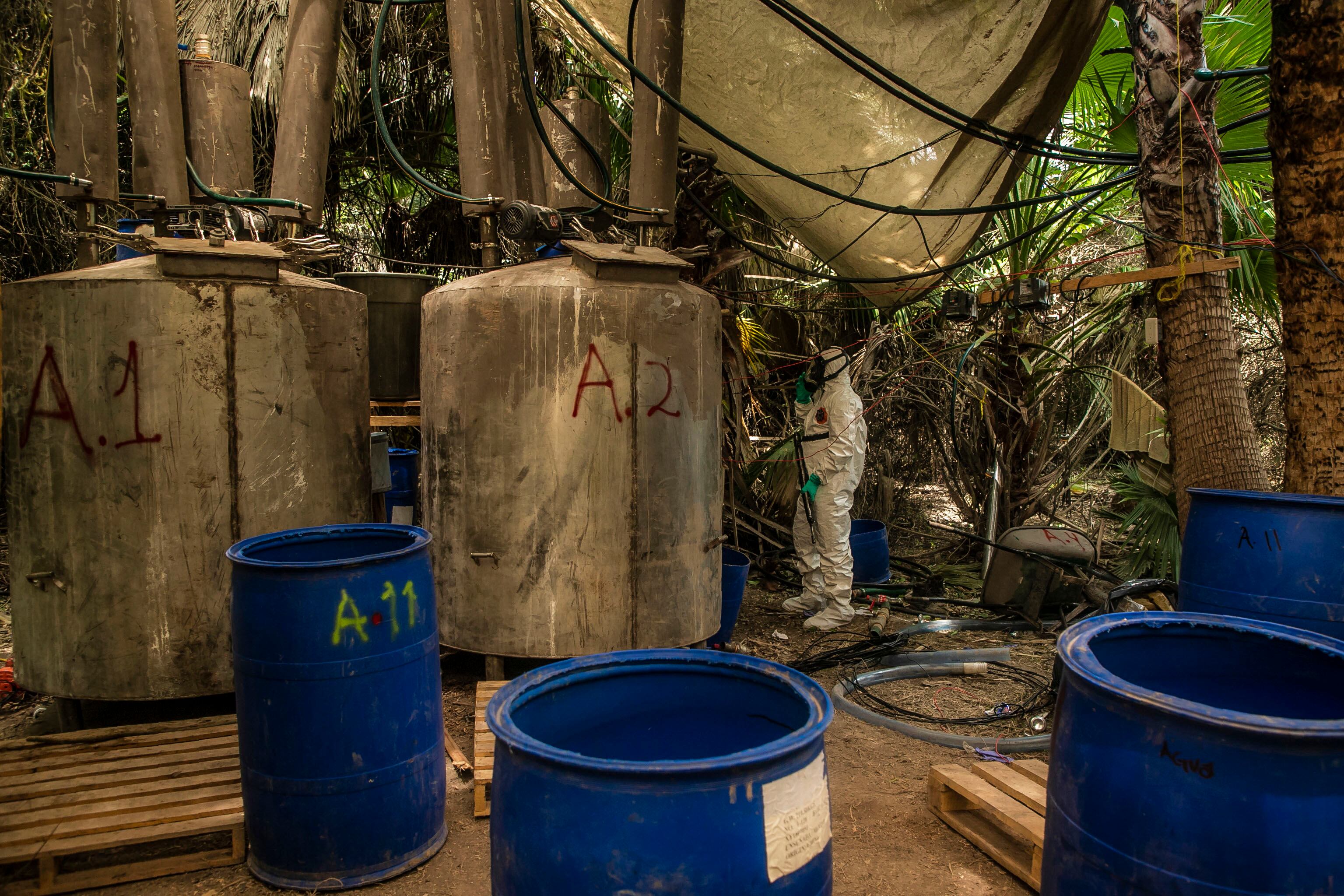 A Sinaloa's state police officer works during the dismantle of one of the three clandestine laboratories producers of synthetic drug, mainly methamphetamine in El Dorado, Sinaloa state, Mexico on June 4, 2019. (Photo by RASHIDE FRIAS / AFP) (Photo credit should read RASHIDE FRIAS/AFP via Getty Images)