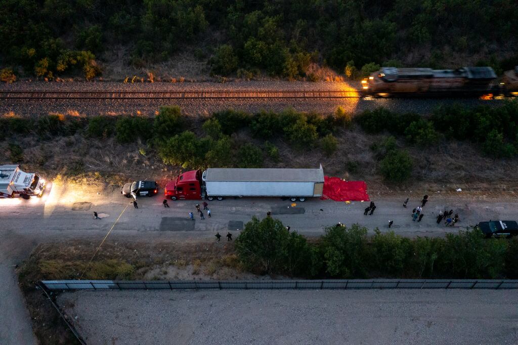SAN ANTONIO, TX - JUNE 27: In this aerial view, members of law enforcement investigate a tractor trailer on June 27, 2022 in San Antonio, Texas. According to reports, at least 46 people, who are believed migrant workers from Mexico, were found dead in an abandoned tractor trailer. Over a dozen victims were found alive, suffering from heat stroke and taken to local hospitals. (Photo by Jordan Vonderhaar/Getty Images)