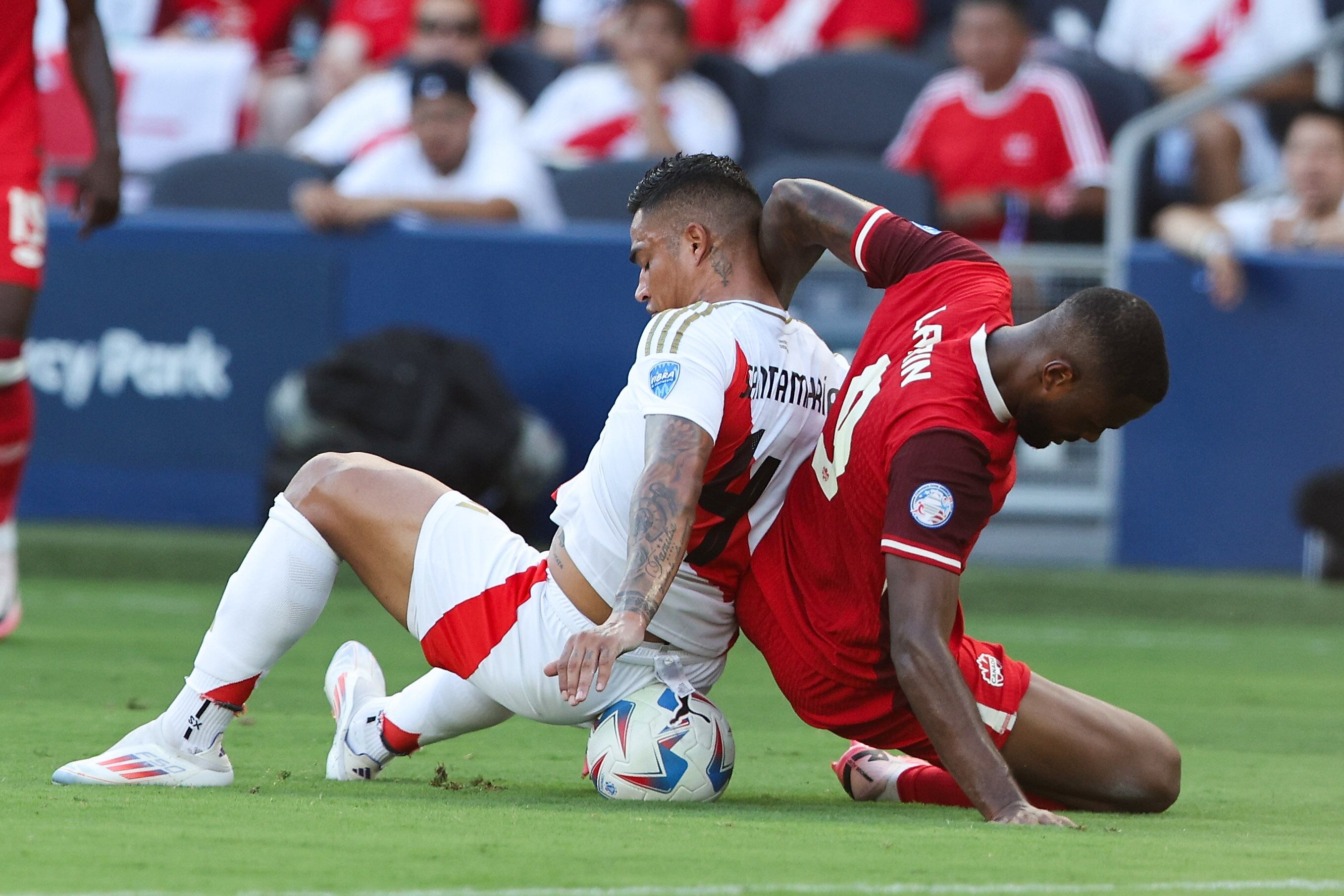 Kansas City (United States), 25/06/2024.- Peru defender Anderson Santamar'Äôa (L) and Canada forward Cyle Larin (R) battle for the ball during the second half of the CONMEBOL Copa America 2024 group A match between Peru and Canada, in Kansas City, Kansas, USA, 25 June 2024. EFE/EPA/WILLIAM PURNELL