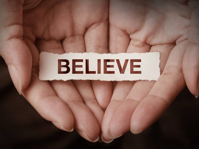 Believe text on hand design concept