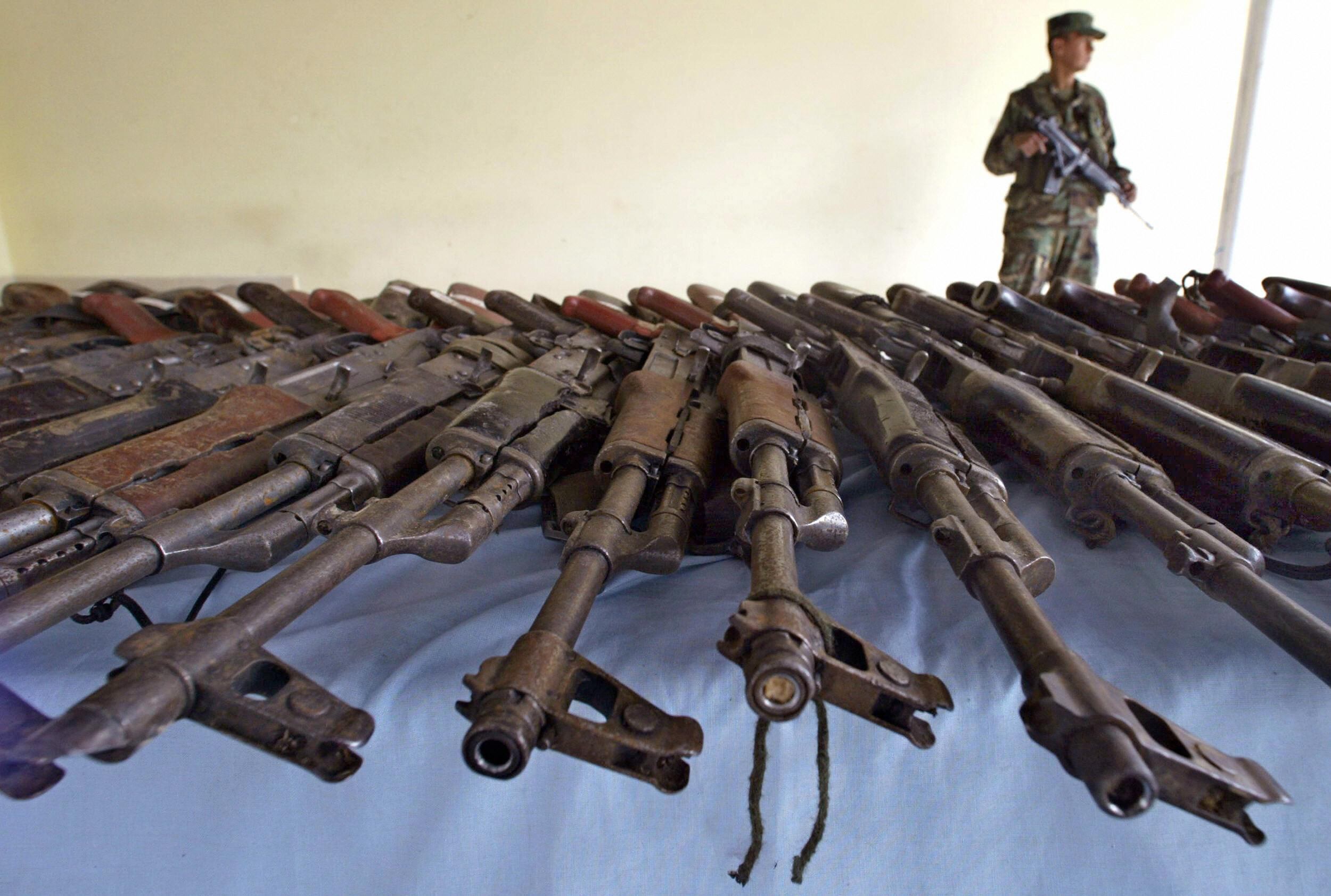 TAURAMENA, COLOMBIA:  Weapons seized to fighters of the Casanare Peasants' Self-Defence (ACC) paramilitary forces (right-wing) captured by the Army  are displayed for the press 29 September, 2004 in Tauramena, Casanare department, southwest of Colombia. Some 175 paramilitary fighters have been captured and 27 killed in combats with the Colombian army in the Casanare department, authorities said.  AFP PHOTO Rodrigo ARANGUA  (Photo credit should read RODRIGO ARANGUA/AFP via Getty Images)