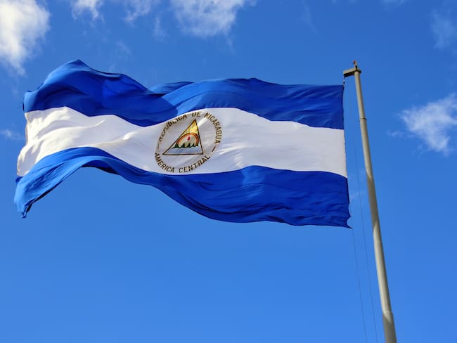 Nicaraguan flag waving in the wind at Plaza de la Revolución / Plaza de la República, Managua