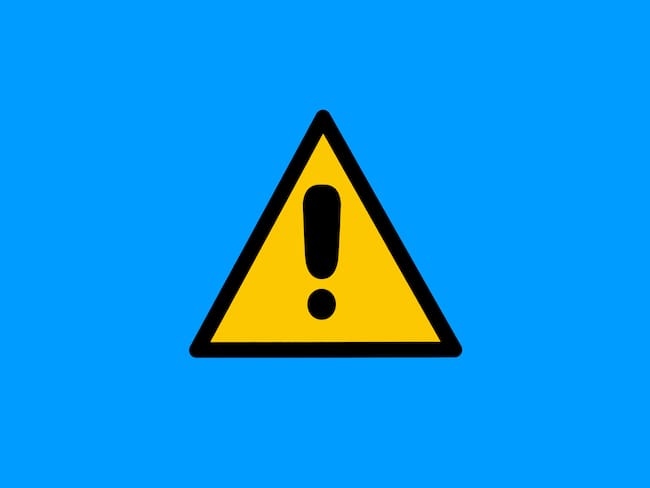Warning sign with yellow and black triangle with exclamation mark, on blue background. Danger, risk, caution, attention, road sign and care concept.