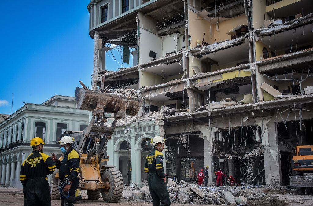 Rescue workers remove debris from the ruins of the Saratoga Hotel, in Havana, on May 8, 2022. - The death toll from an accidental explosion at a luxury hotel in central Havana rose to 30 on Sunday, authorities said, as firefighters continued to comb through the rubble. (Photo by ADALBERTO ROQUE / AFP) (Photo by ADALBERTO ROQUE/AFP via Getty Images)