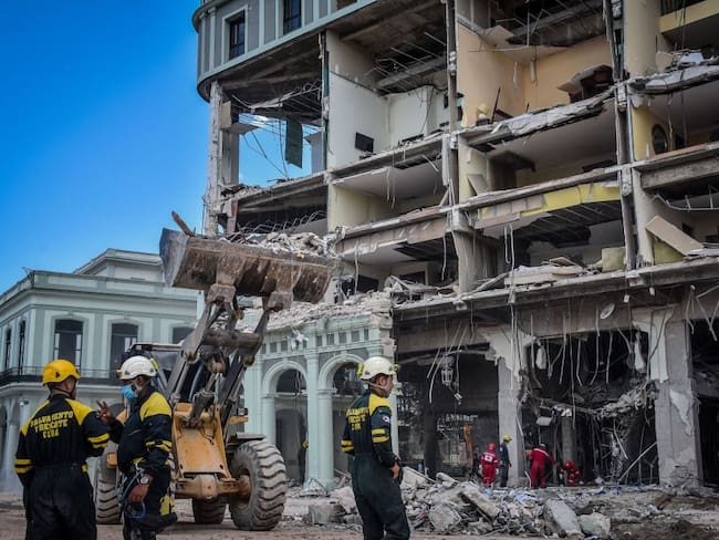 Rescue workers remove debris from the ruins of the Saratoga Hotel, in Havana, on May 8, 2022. - The death toll from an accidental explosion at a luxury hotel in central Havana rose to 30 on Sunday, authorities said, as firefighters continued to comb through the rubble. (Photo by ADALBERTO ROQUE / AFP) (Photo by ADALBERTO ROQUE/AFP via Getty Images)