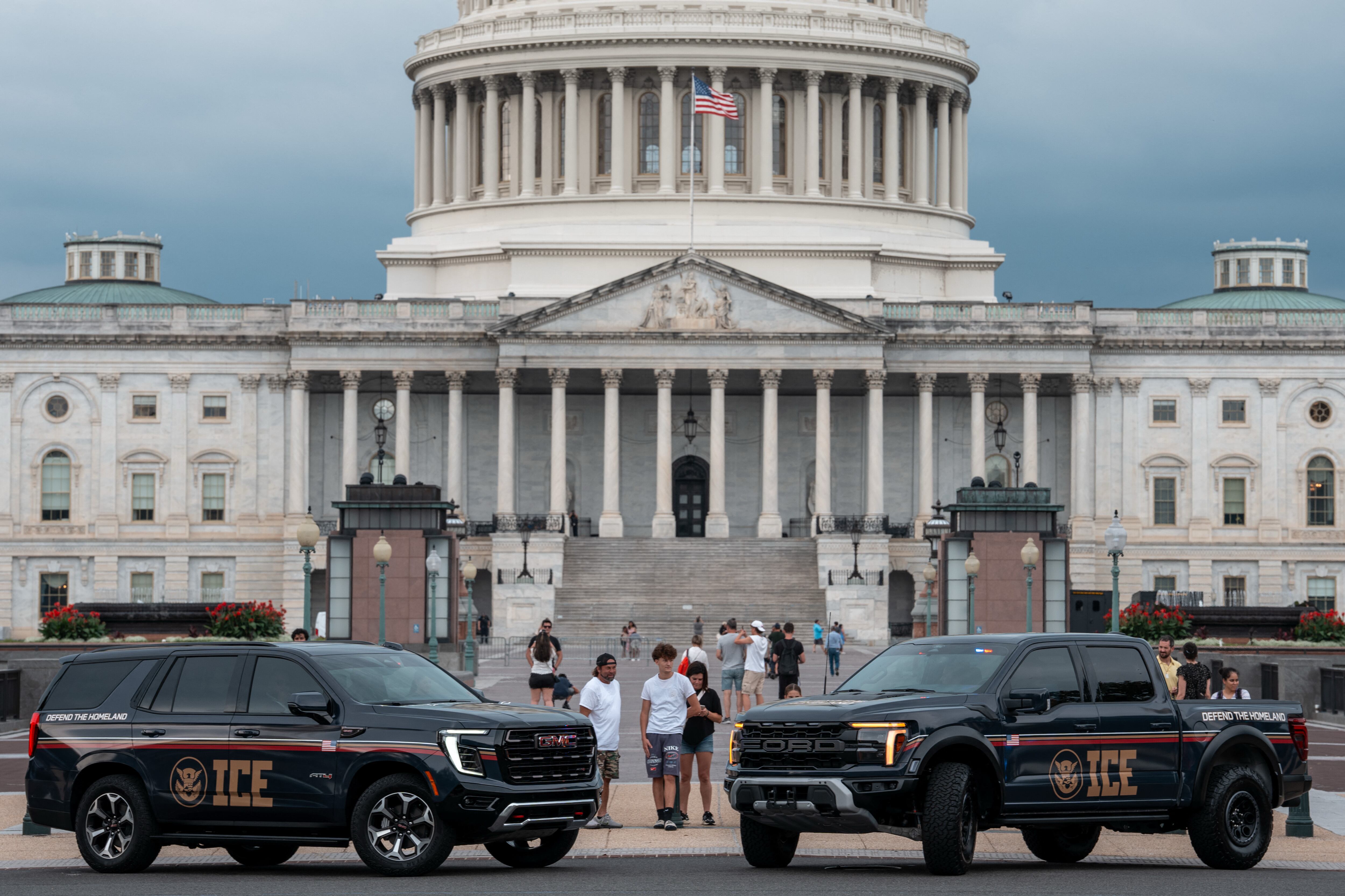 WASHINGTON, DC - AUGUST 13: An Immigration and Customs Enforcement (ICE) branded GMC SUV and an Immigration and Customs Enforcement (ICE) branded Ford pickup truck are parked at the US Capitol on August 13, 2025 in Washington, DC. U.S. President Donald Trump announced plans to deploy federal officers and the National Guard to the District in order to place the DC Metropolitan Police Department under federal control and assist in crime prevention in the nation's capital.   Andrew Leyden/Getty Images/AFP (Photo by Andrew Leyden / GETTY IMAGES NORTH AMERICA / Getty Images via AFP)
