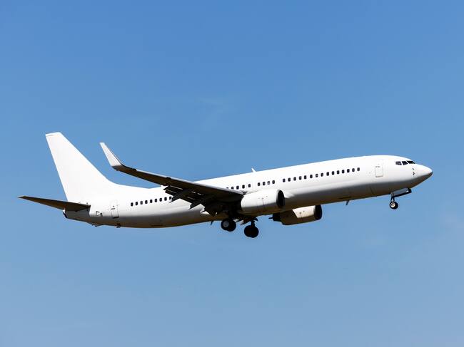 White passenger aircraft in the blue sky