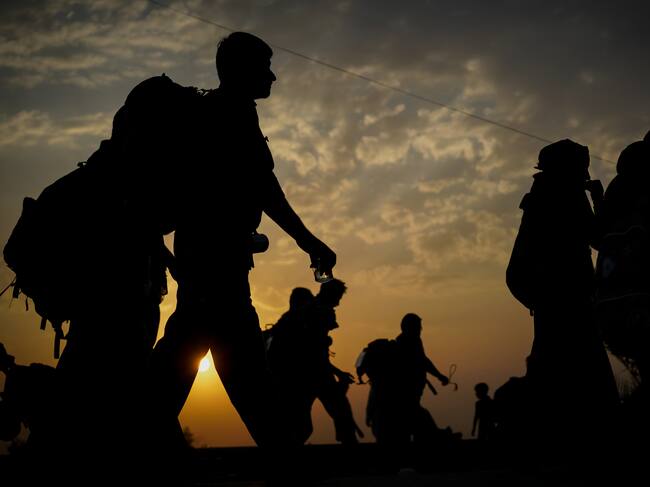 Immigrants walking before sunset