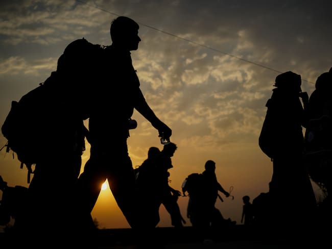 Immigrants walking before sunset