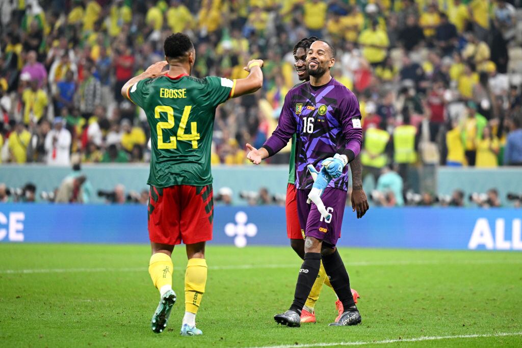 LUSAIL CITY, QATAR - DECEMBER 02: Enzo Ebosse and Devis Epassy of Cameroon interact after the FIFA World Cup Qatar 2022 Group G match between Cameroon and Brazil at Lusail Stadium on December 02, 2022 in Lusail City, Qatar. (Photo by Matthias Hangst/Getty Images)