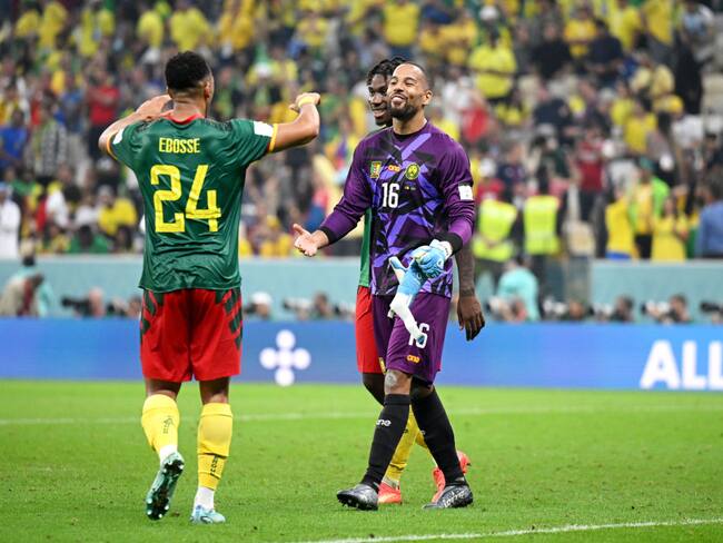 LUSAIL CITY, QATAR - DECEMBER 02: Enzo Ebosse and Devis Epassy of Cameroon interact after the FIFA World Cup Qatar 2022 Group G match between Cameroon and Brazil at Lusail Stadium on December 02, 2022 in Lusail City, Qatar. (Photo by Matthias Hangst/Getty Images)