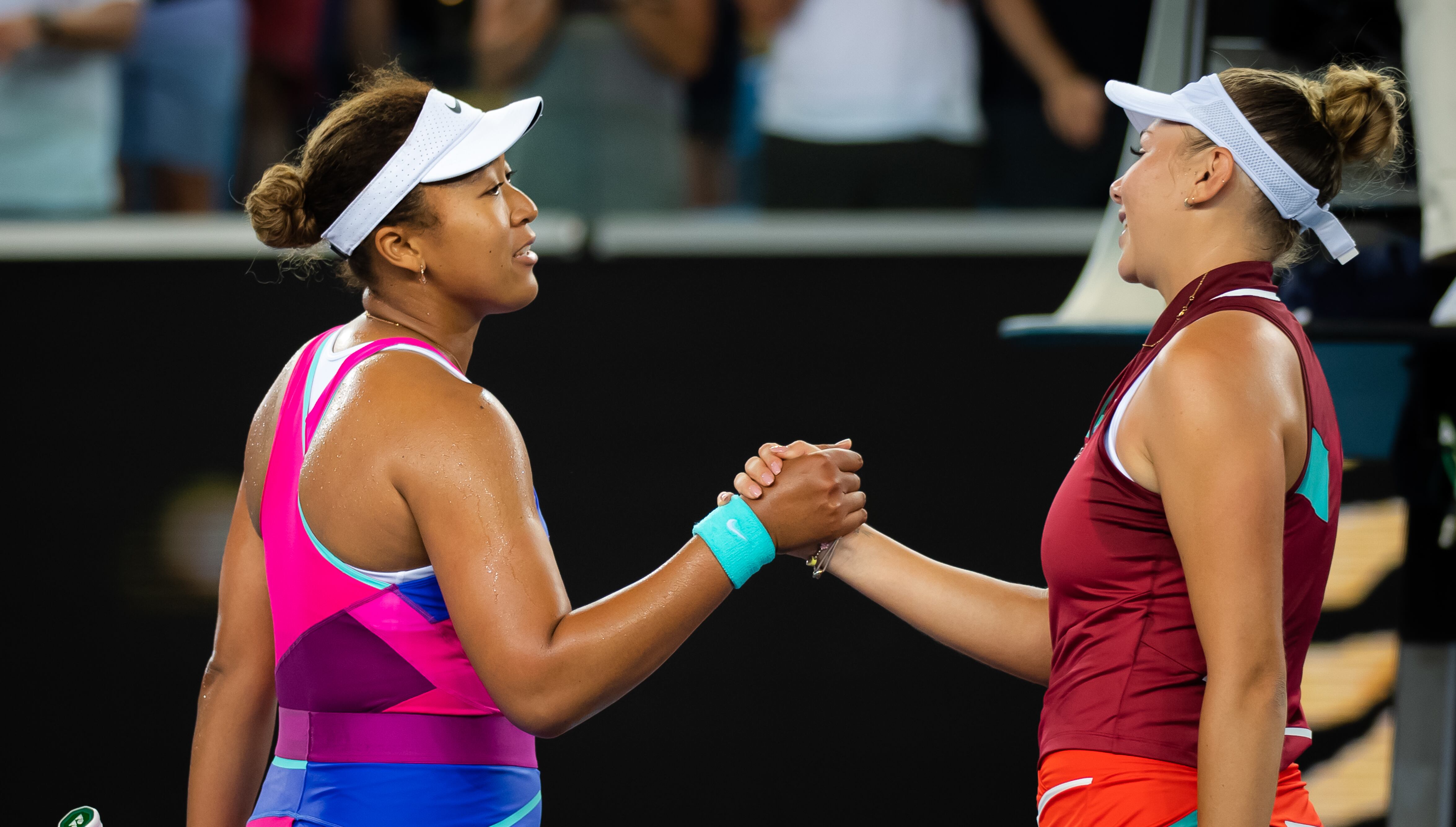 MELBOURNE, AUSTRALIA - JANUARY 21: Naomi Osaka of Japan and Amanda Anisimova of the United States meet at the net after Anisimovas victory in the third round singles match at the 2022 Australian Open at Melbourne Park on January 21, 2022 in Melbourne, Australia. (Photo by Robert Prange/Getty Images)