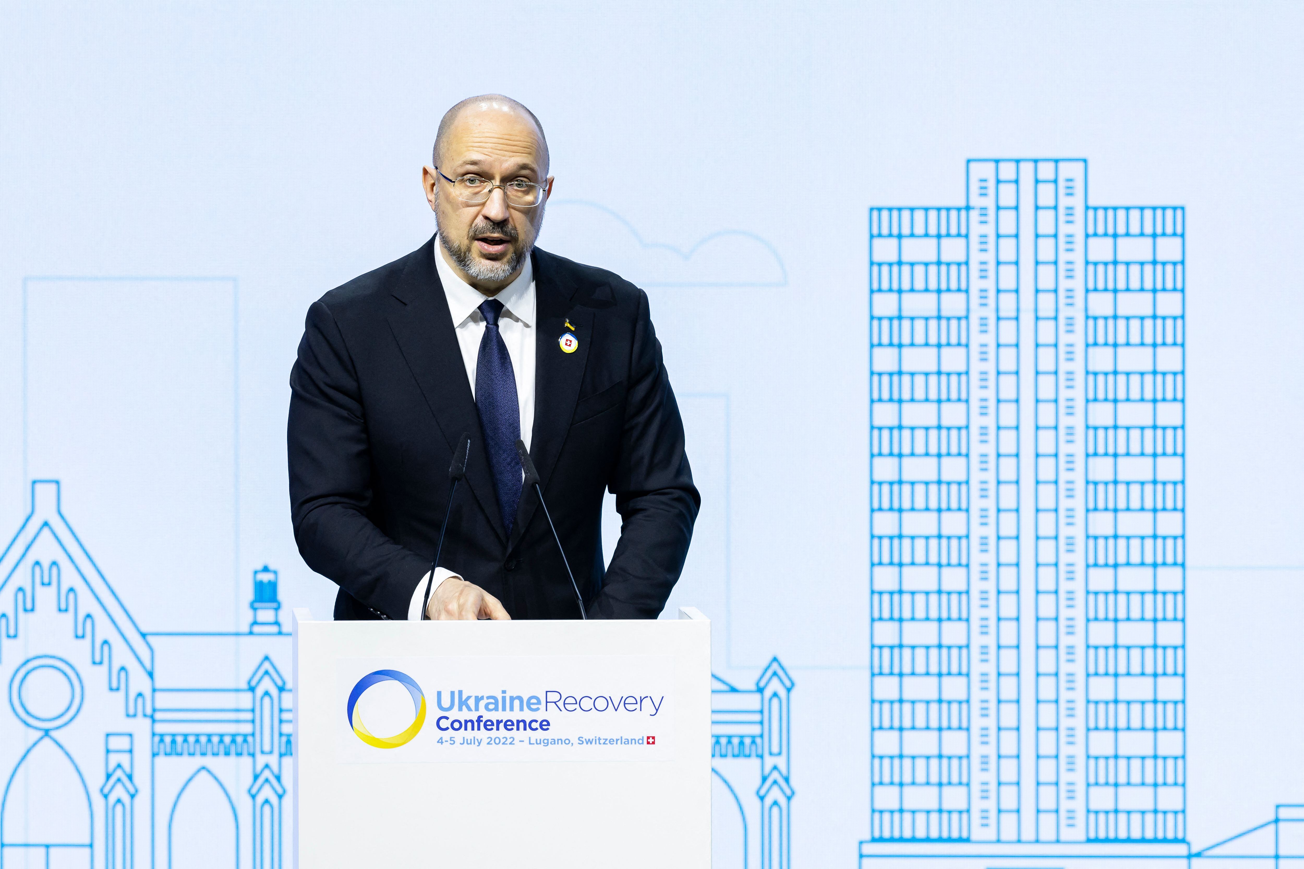 Ukrainian Prime Minister Denys Shmyhal delivers a speech during the Economic Forum official opening at the Ukraine Recovery Conference URC, in Lugano on July 5, 2022. - The URC is organised to initiate the political process for the recovery of Ukraine after the attack of Russia to its territory. (Photo by MICHAEL BUHOLZER / KEYSTONE / AFP) (Photo by MICHAEL BUHOLZER/KEYSTONE/AFP via Getty Images)