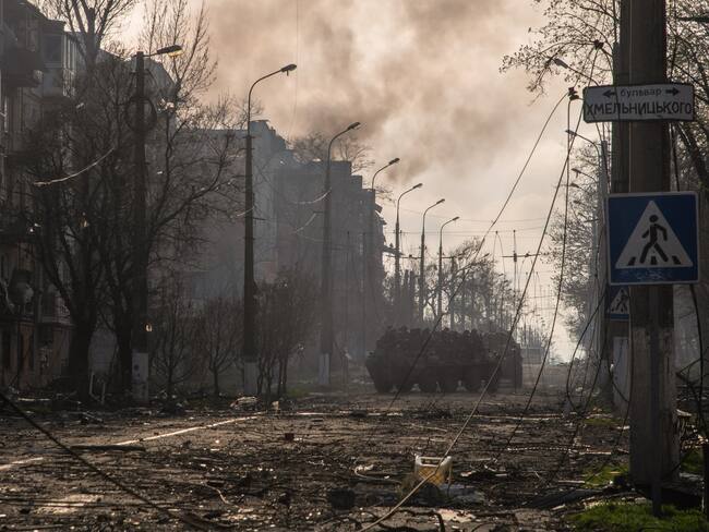 MARIUPOL, UKRAINE - 2022/04/16: Donetsk People&#039;s Republic BTR armoured personnel carriers drive through a burning street in Eastern Mariupol. The battle between Russian / Pro Russian forces and the defending Ukrainian forces led by the Azov battalion continues in the port city of Mariupol. (Photo by Maximilian Clarke/SOPA Images/LightRocket via Getty Images)