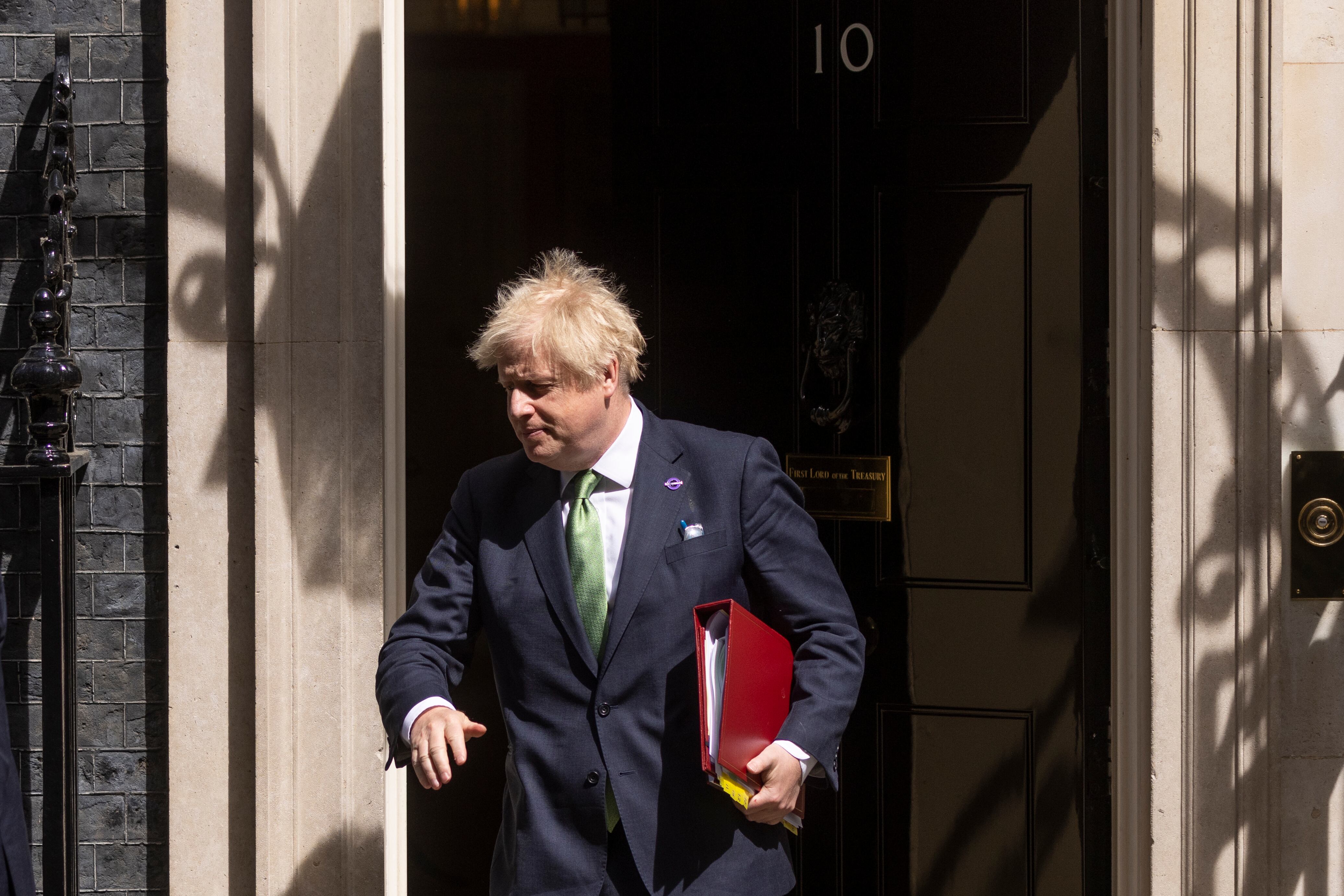 LONDON, ENGLAND - MAY 18: British Prime Minister Boris Johnson leaves 10 Downing Street to attend the weekly Prime Ministers Questions in the House of Commons on May 18, 2022 in London, England. (Photo by Dan Kitwood/Getty Images)