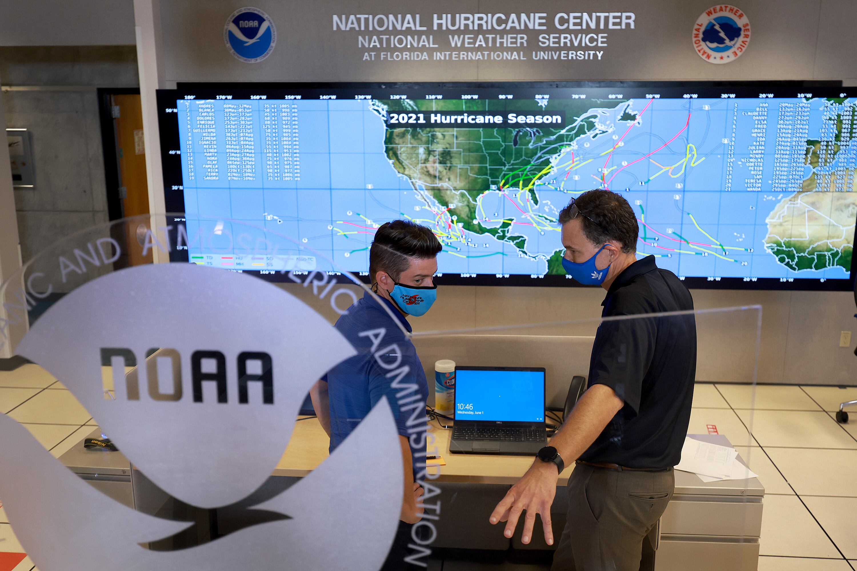 MIAMI, FLORIDA - JUNE 01: Robbie Berg (L), Senior Hurricane Specialist, and Jamie Rhome, Deputy Director of NOAA's National Hurricane Center, interact on the floor of the National Hurricane Center on June 01, 2022 in Miami, Florida. As the 2022 Atlantic hurricane season begins, remnants of the former Pacific hurricane Agatha are expected to reform in the Gulf of Mexico, possibly as a tropical storm, in the next five days, according to the National Hurricane Center. (Photo by Joe Raedle/Getty Images)