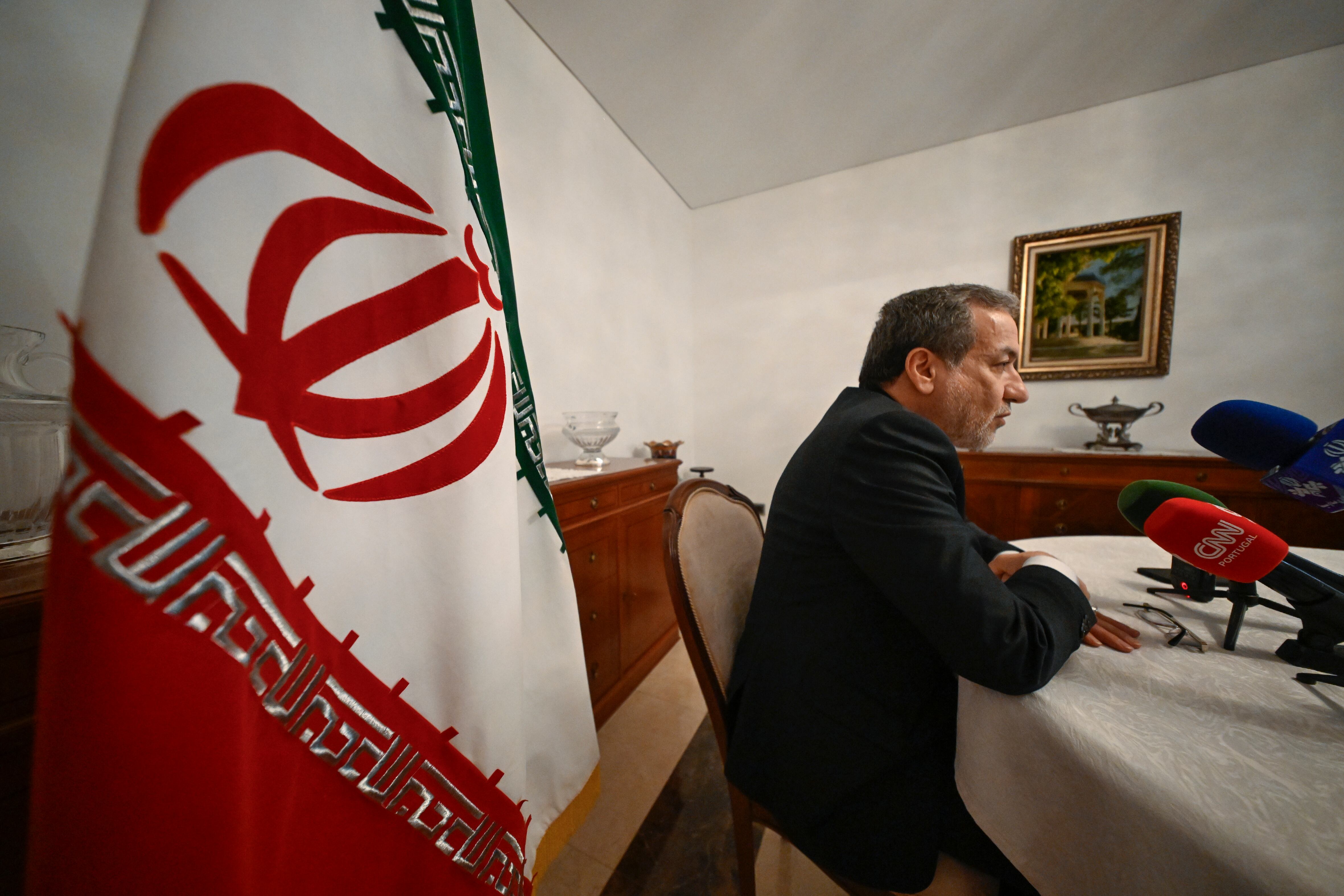 LISBON, PORTUGAL - NOVEMBER 27: Abbas Araghchi, Minister of Foreign Affairs of Iran, sits by the Iranian flag as he talks to journalists at the Iranian Ambassador residency. (Corbis via Getty Images)