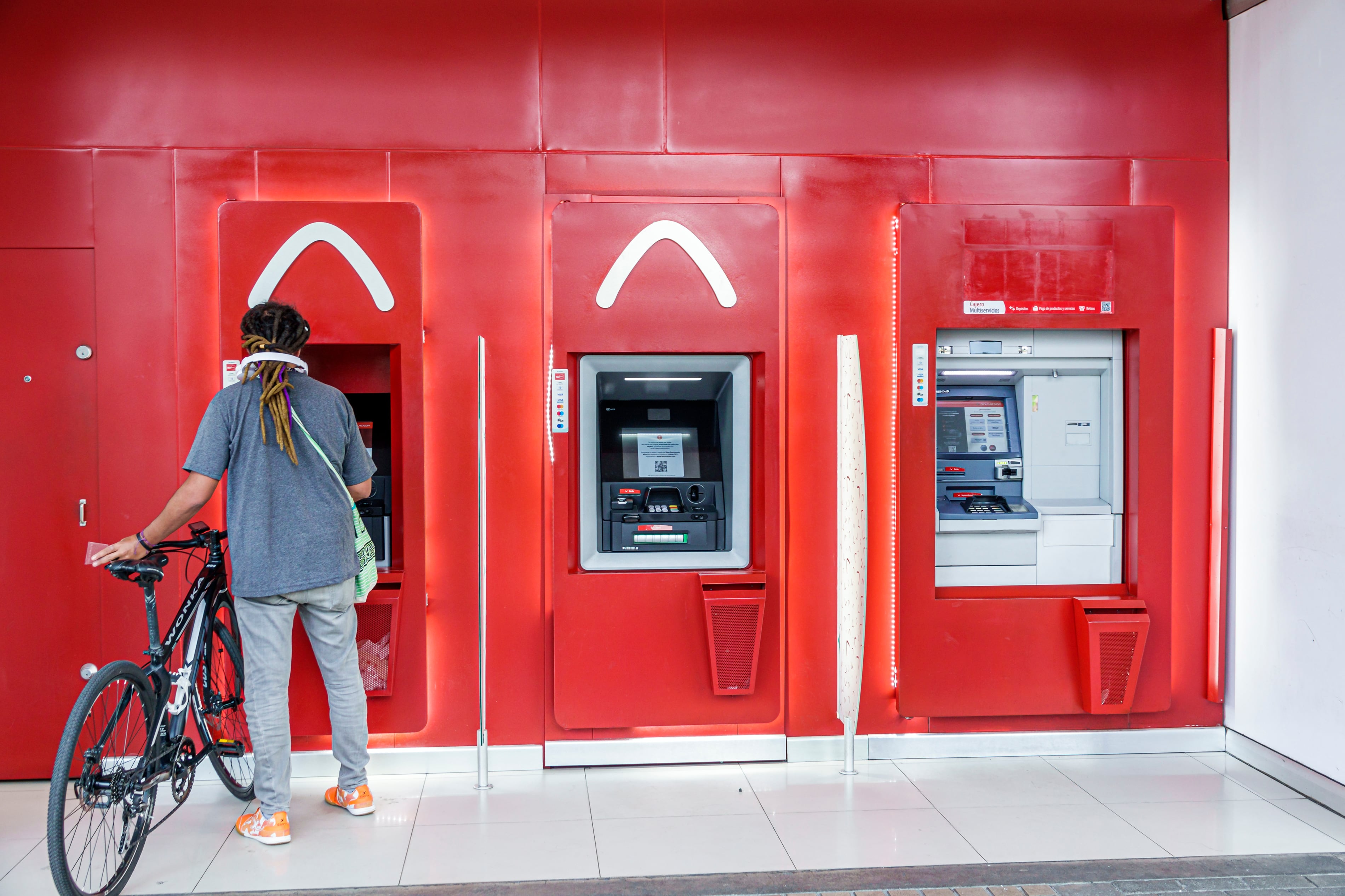Bogota, Colombia, Avenida El Dorado, Calle 26, Davivienda Colombian bank, customer with bike using ATM. (Jeffrey Greenberg/Universal Images Group via Getty Images)