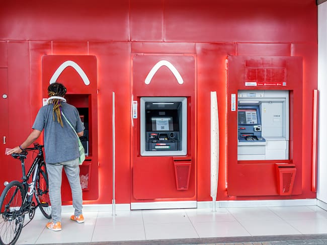 Bogota, Colombia, Avenida El Dorado, Calle 26, Davivienda Colombian bank, customer with bike using ATM. (Jeffrey Greenberg/Universal Images Group via Getty Images)