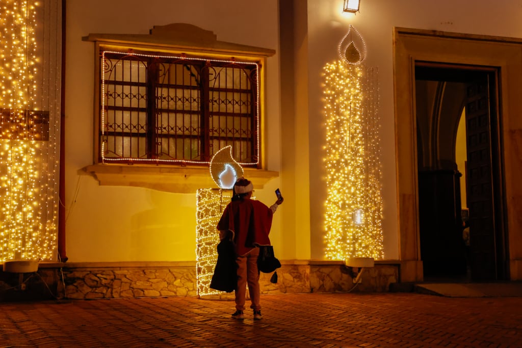 People enjoy the Christmas figures and decorations illuminated with lights, displayed ahead of Christmas at the Monserrate hill in Bogota, Colombia on December 19, 2023. (Photo by Juancho Torres/Anadolu via Getty Images)
