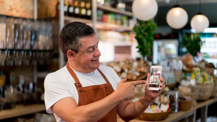 Dueño de negocio colombiano abriendo su tienda virtual de comida (Getty Images)