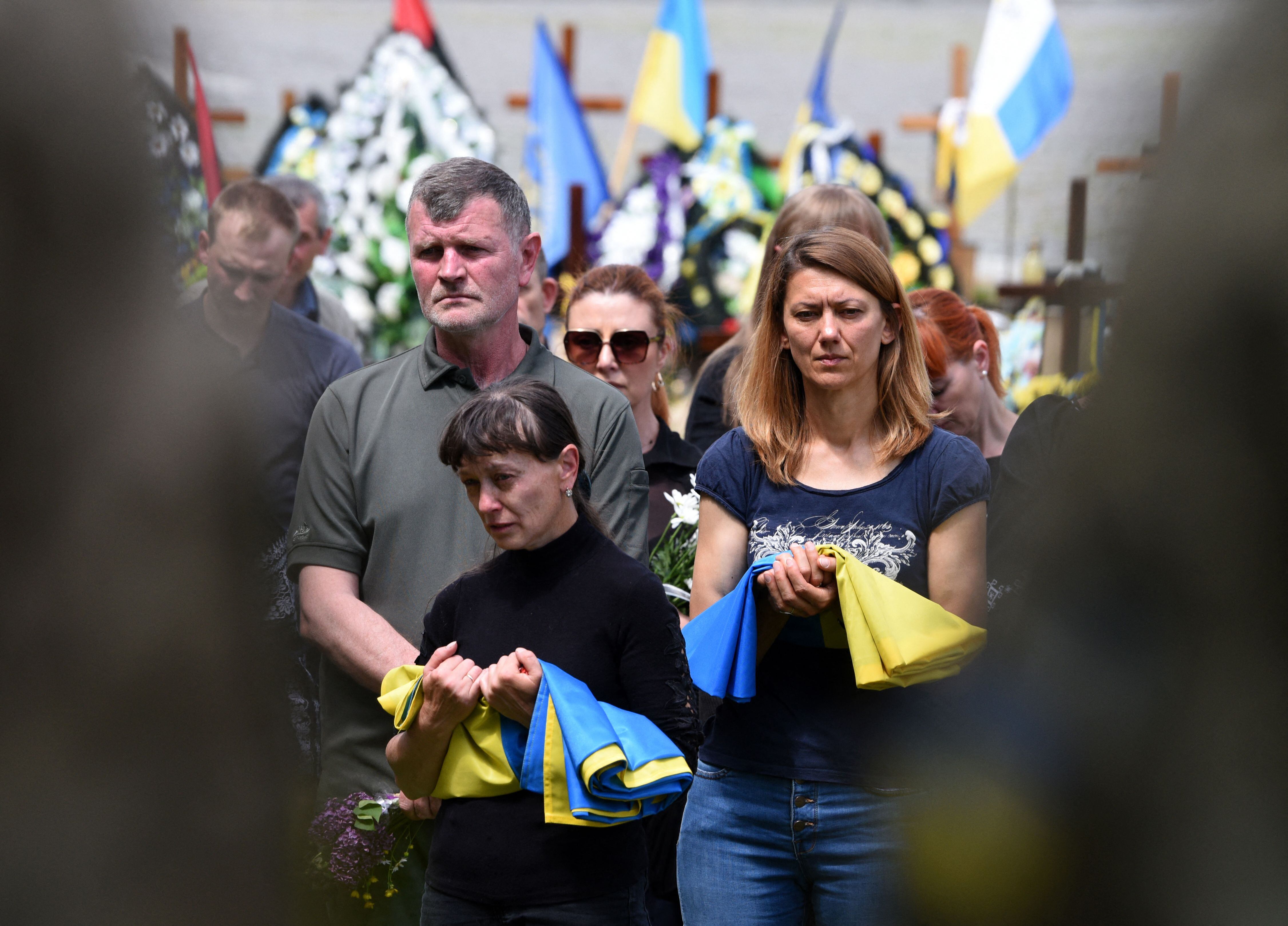 Relatives react during the funeral of Andriy Vertiev and Serhiy Evtushenko, Ukrainian servicemen, killed during the Russian invasion of Ukraine at Lychakiv cemetery in the western Ukrainian city of Lviv, on May 25, 2022. (Photo by Yuriy Dyachyshyn / AFP) (Photo by YURIY DYACHYSHYN/AFP via Getty Images)