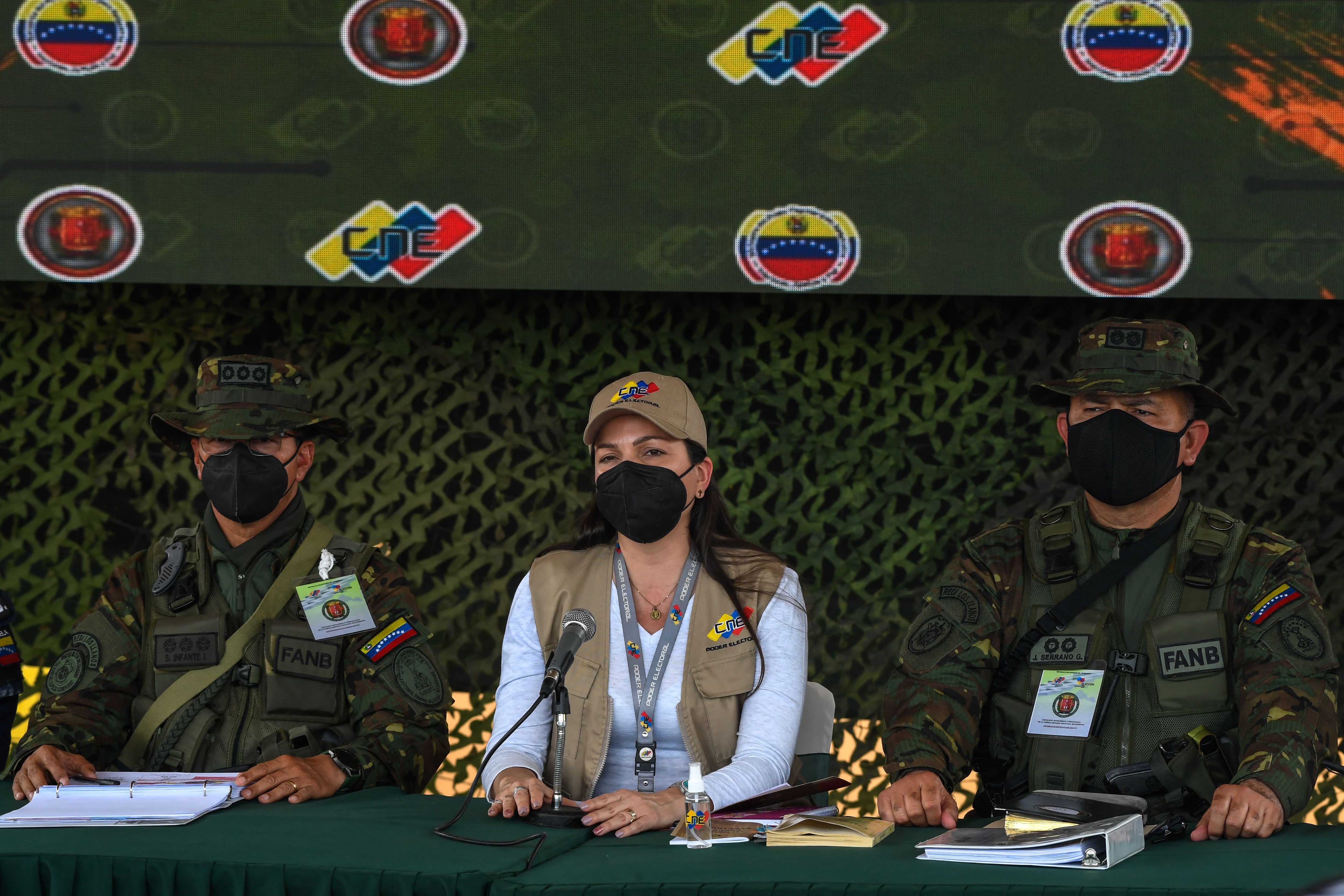 (L to R) Venezuelan Major General Santiago Alejandro Infante, Director of the Barinas Regional Electoral Office Denyssis Perez and Commander Jose Rafael Serrano, offer a press conference, at Colonel Mauricio Encinoso helicopter battalion, in Barinas city, Venezuela, on January 7, 2022, two days before the state of Barinas holds a re-run of the gubernatorial election. (Photo by Federico Parra / AFP) (Photo by FEDERICO PARRA/AFP via Getty Images)