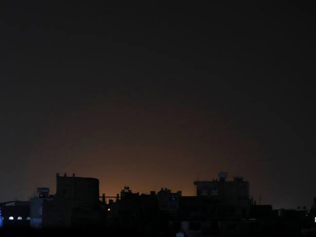 Sana'a (Yemen), 03/02/2024.- A general view of light shining behind buildings at a neighborhood following strikes in Sana'a, Yemen, 03 February 2024. The US-led coalition has conducted new strikes against Yemen's Houthi positions in the capital Sana'a and others cities under Houthis control in response to increased Houthi attacks on shipping in the Red Sea and the Gulf of Aden, Houthis-run al-Masirah TV reported. In January 2024, the US Department of State designated Yemen's Houthis as a 'Specially Designated Global Terrorist group' due to their increased attacks on shipping lanes. In December 2023, the US Department of Defense announced a multinational operation to safeguard trade and protect ships in the Red Sea in response to the escalation of Houthi attacks. (Terrorista) EFE/EPA/YAHYA ARHAB