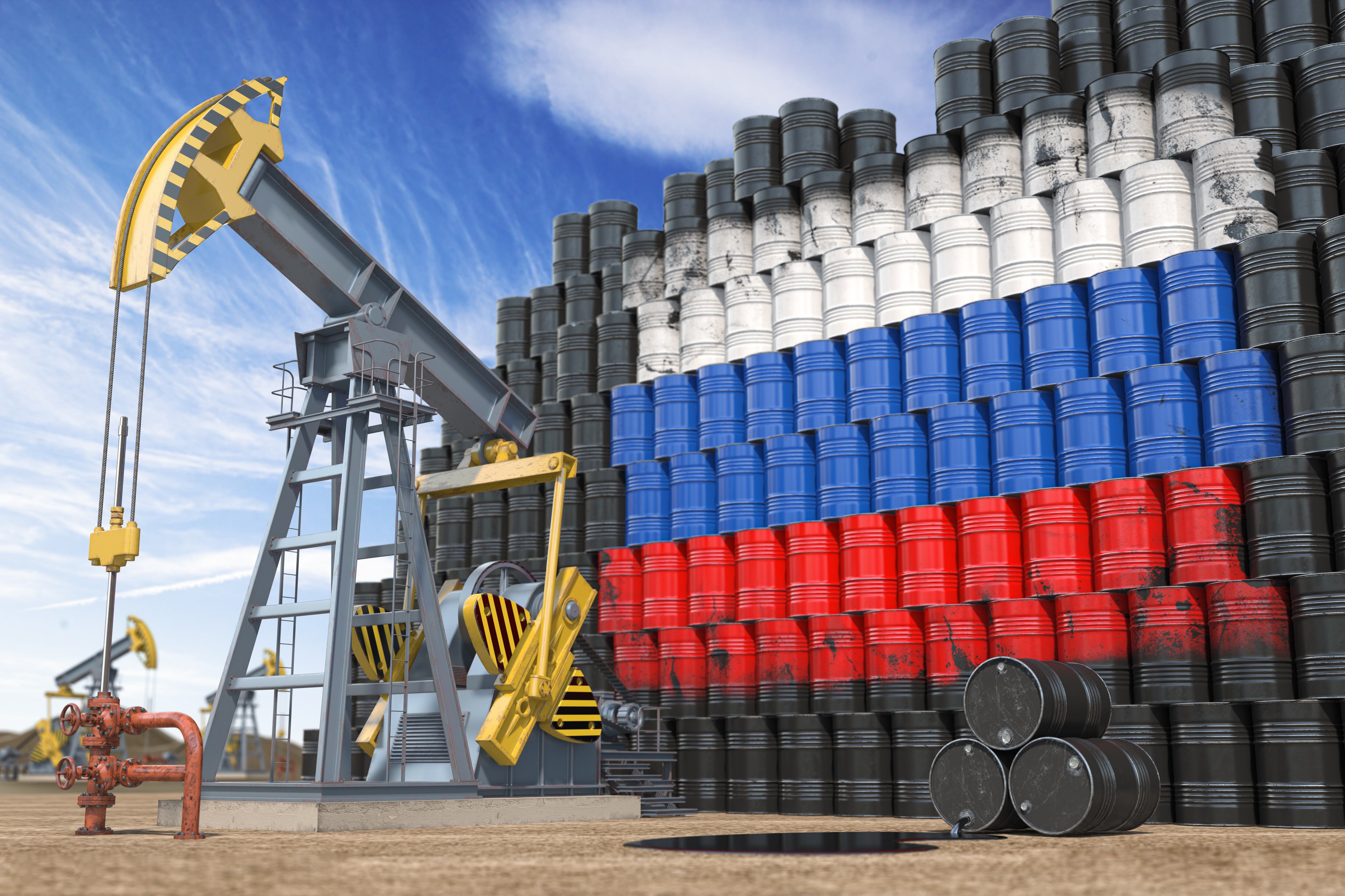 Oil production and extraction in Russia. Oil pump jack and oil barrels with Russia flag. 3d illustration. Photo: Getty Images